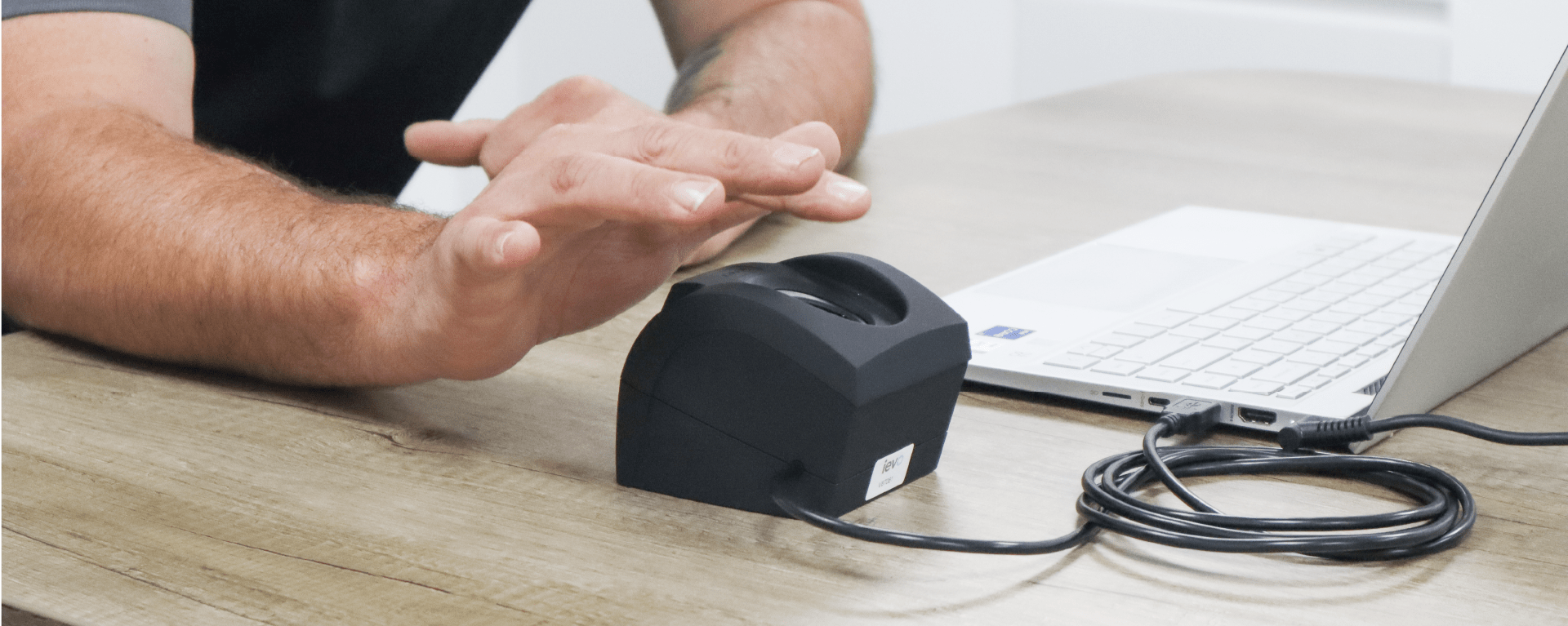 ievo desktop biometric fingerprint enrolment reader being used next to a laptop